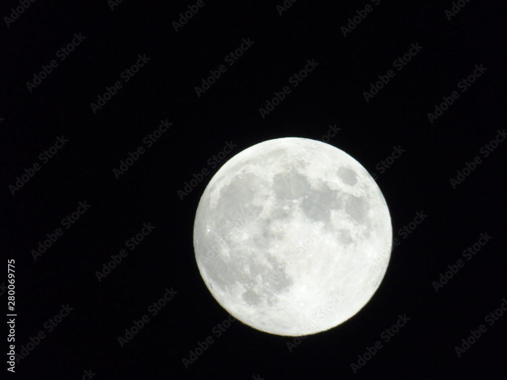 An amazing photography of the full moon over the city of Genova by night with a great clear sky in background and some stars An amazing photography of the full moon over the city of Genova by night with a great clear sky in background and some stars