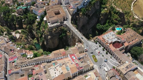 Aerial view of cityscape of Ronda, famous historic city with impressive arch bridge Puente Nuevo over gorge El Tajo - landscape panorama of Andalusia from above, province of Malaga, Spain, Europe