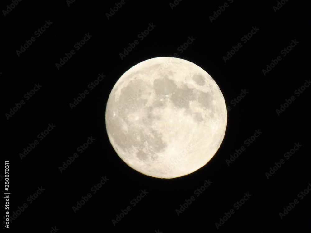 An amazing photography of the full moon over the city of Genova by night with a great clear sky in background and some stars An amazing photography of the full moon over the city of Genova by night with a great clear sky in background and some stars