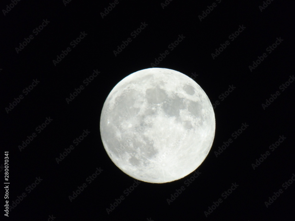 An amazing photography of the full moon over the city of Genova by night with a great clear sky in background and some stars An amazing photography of the full moon over the city of Genova by night with a great clear sky in background and some stars