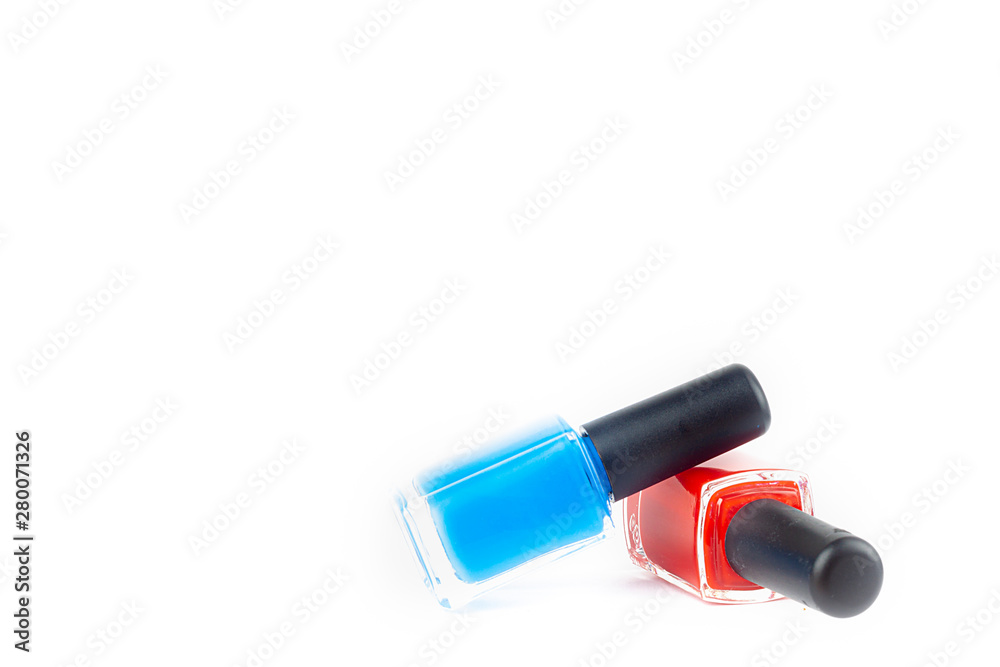 RED AND BLUE BAIL LACQUER IN CRYSTAL BOTTLES ON WHITE BACKGROUND. COSMETICS AND BEAUTY RED AND BLUE BAIL LACQUER IN CRYSTAL BOTTLES ON WHITE BACKGROUND. COSMETICS AND BEAUTY