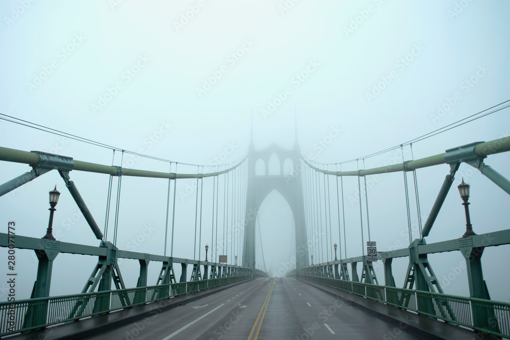 bridge in city on foggy day