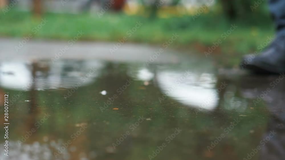 Man in black shoes stepping into the puddle in slow motion 180fps Man in black shoes stepping into the puddle in slow motion 180fps