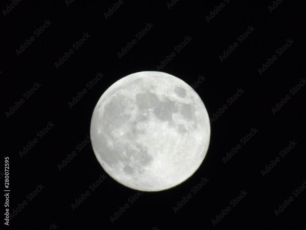 An amazing photography of the full moon over the city of Genova by night with a great clear sky in background and some stars An amazing photography of the full moon over the city of Genova by night with a great clear sky in background and some stars