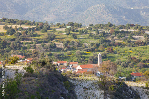 Traditional rural greek scenic mountaine view, olives and other trees grow on slopes, houses with red roofs