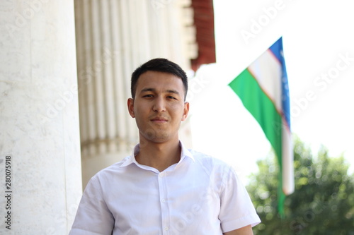 man on the background of the Uzbek flag photo