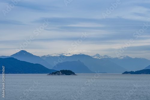 Breathtaking landscape in Alaska with mountains and blue sky. Panoramic view from the cruise ship in the USA.