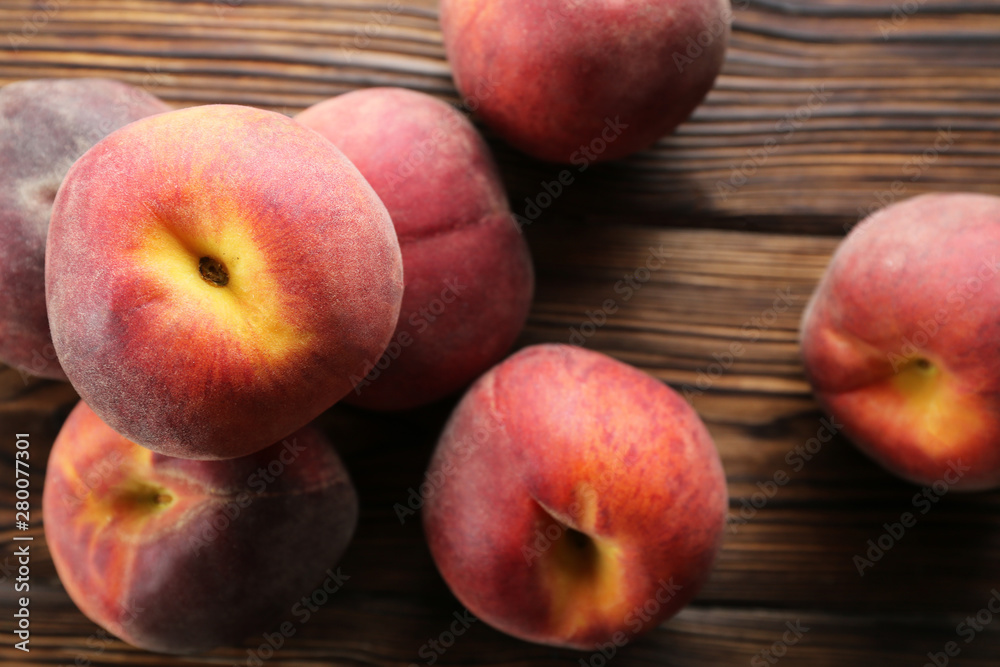 Bunch of ripe organic peaches in pile on textured table background. Local produce harvest heap on vintage style countertop. Clean eating concept. Top view, close up, copy space for text. Bunch of ripe organic peaches in pile on textured table background. Local produce harvest heap on vintage style countertop. Clean eating concept. Top view, close up, copy space for text.