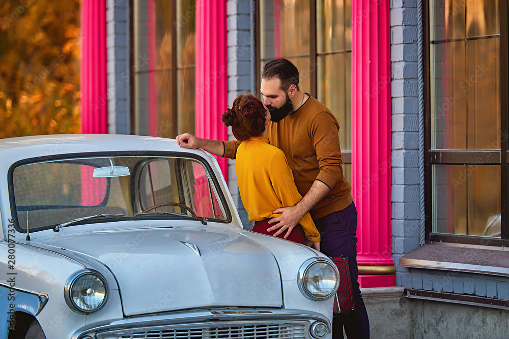 Couple in love near the car in retro style