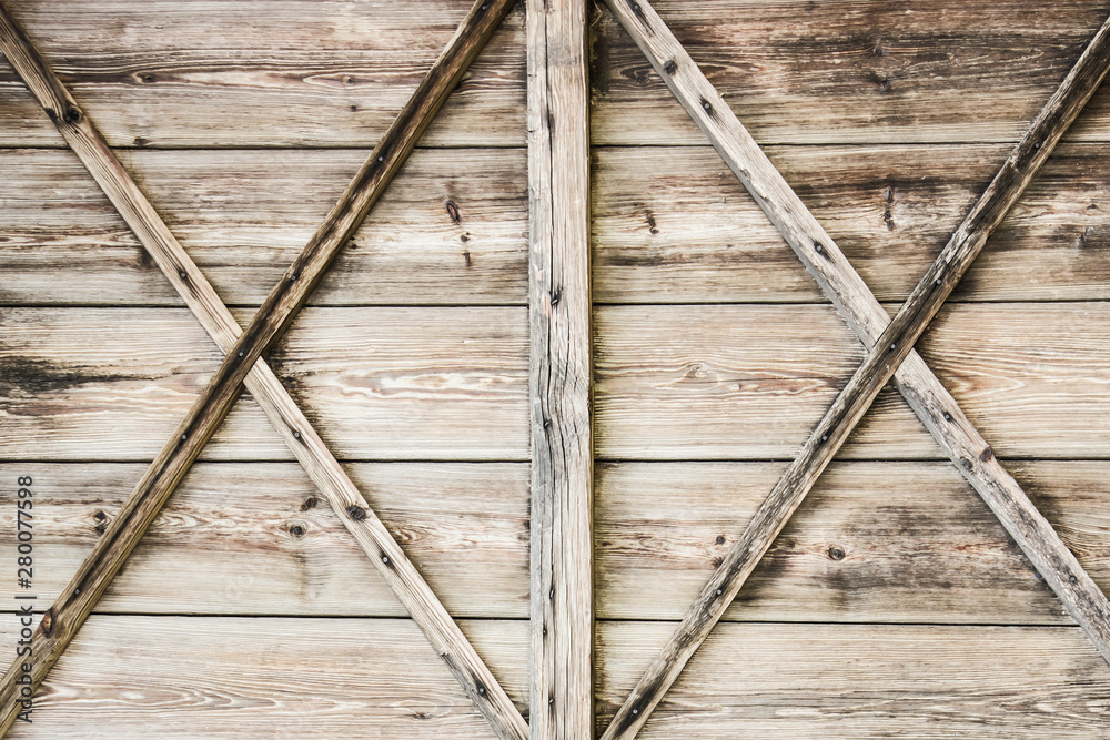 Fototapeta premium Wooden barn door texture. Rustic desks brown wall background.