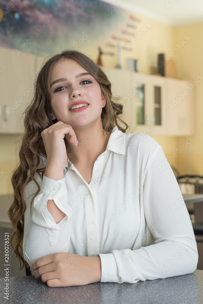 Fototapeta premium Back to school and happy time. Cute teenage girl is sitting at a desk indoors. Student is learning in class