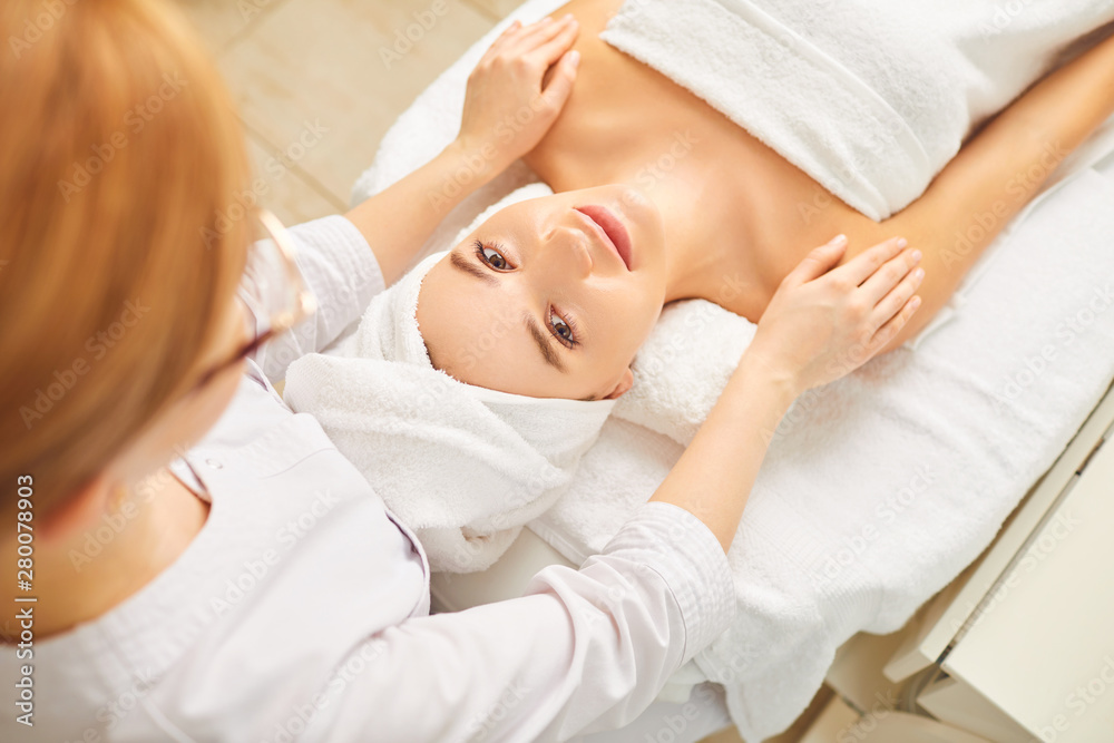 Beautiful woman lying on a table cosmetologist in the beauty salon. Beautiful woman lying on a table cosmetologist in the beauty salon.