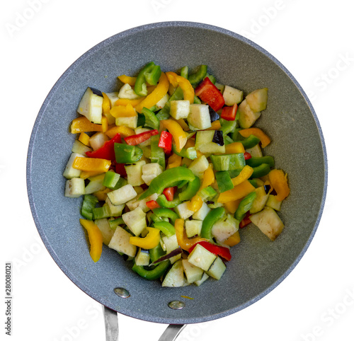 Mixed raw sliced vegetables in a pan, isolated