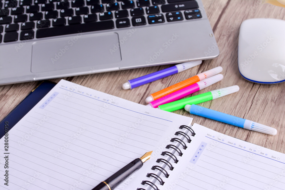 Laptop, notebook with magnifying glass on wooden table Laptop, notebook with magnifying glass on wooden table