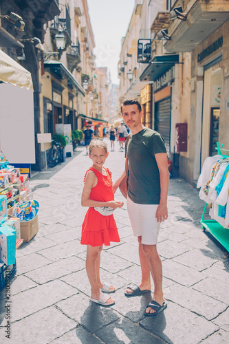 Happy mother and little adorable kid on cozy street during italian vacation. © travnikovstudio