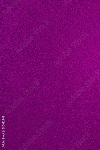 big and small water drops on purple background