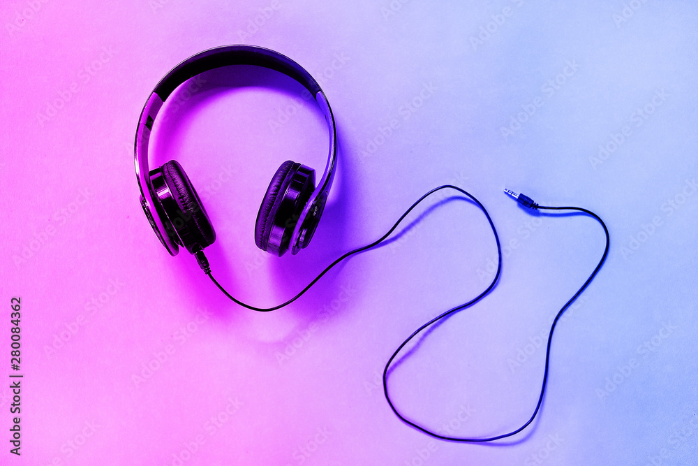 Headphones on neon background with free text space. Music concept. Headphones on neon background with free text space. Music concept.