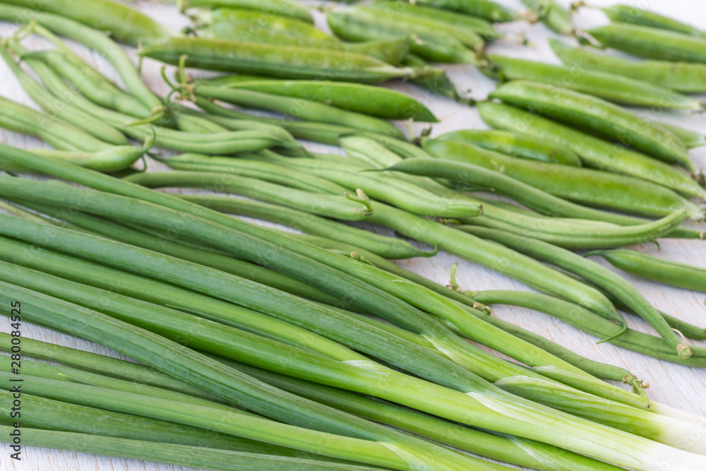 A set of green vegetables: onions, peas, asparagus, top view A set of green vegetables: onions, peas, asparagus, top view