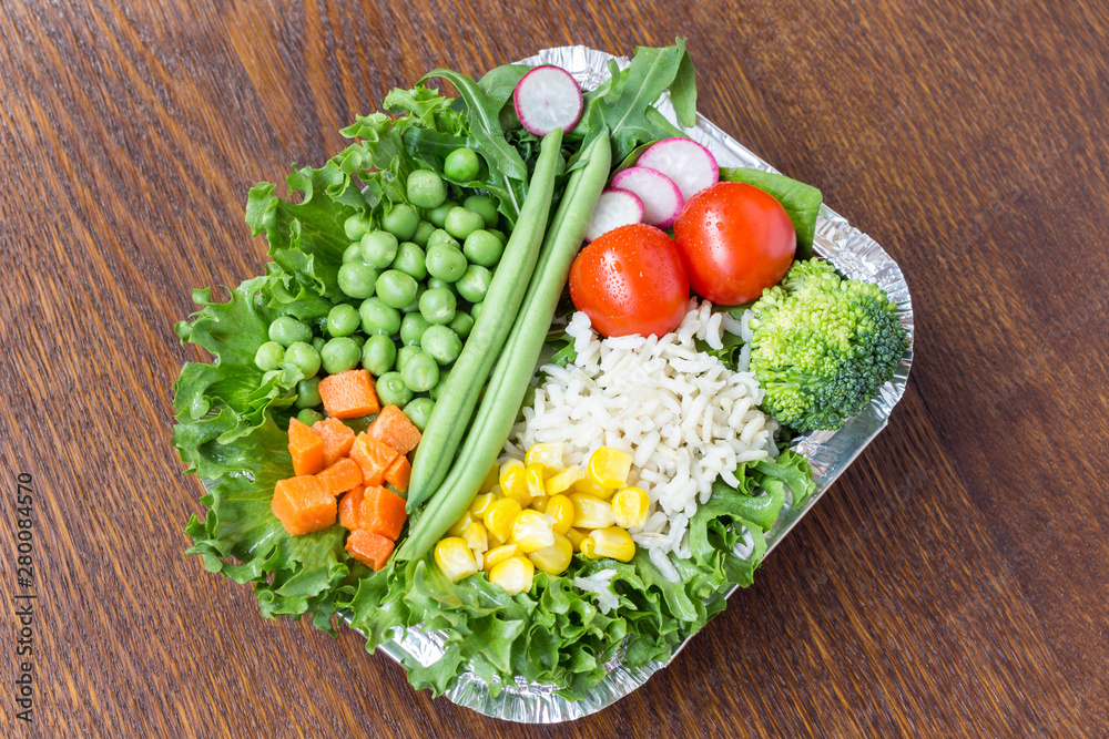 A set of vegetables with rice for a healthy diet: corn, peas, asparagus, carrots, broccoli, lettuce A set of vegetables with rice for a healthy diet: corn, peas, asparagus, carrots, broccoli, lettuce