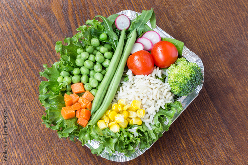 A set of vegetables with rice for a healthy diet: corn, peas, asparagus, carrots, broccoli, lettuce