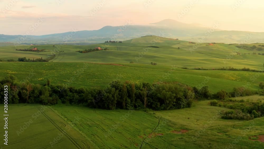 Flying over the amazing rolling hills of Tuscany Italy at sunset