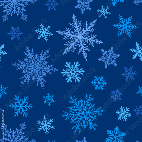 Christmas seamless pattern of complex big and small snowflakes in white colors on blue background