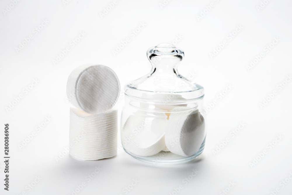 cotton sponges on a white background in a glass jar