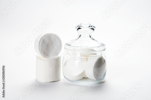 cotton sponges on a white background in a glass jar