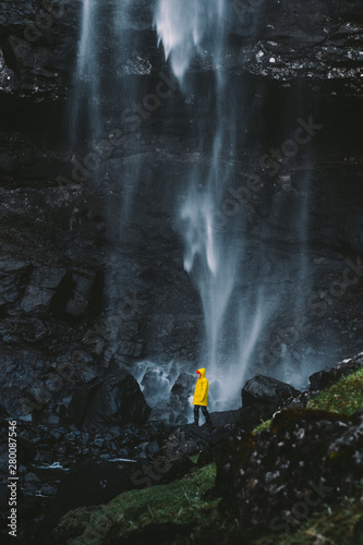 Fossa Waterfall Faroe Islands Traveler in yellow jacket