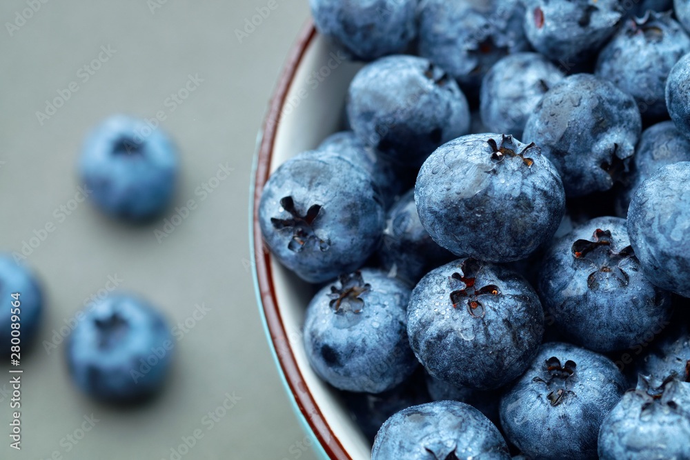 Fresh selected blueberries in bowl on dark gray table background Fresh selected blueberries in bowl on dark gray table background