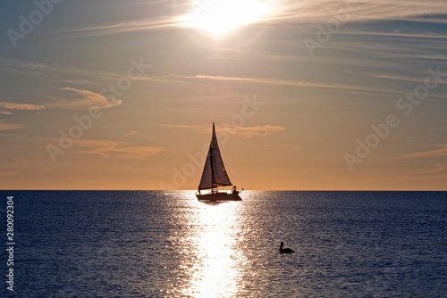 Sailboat under the Sun at Sunset