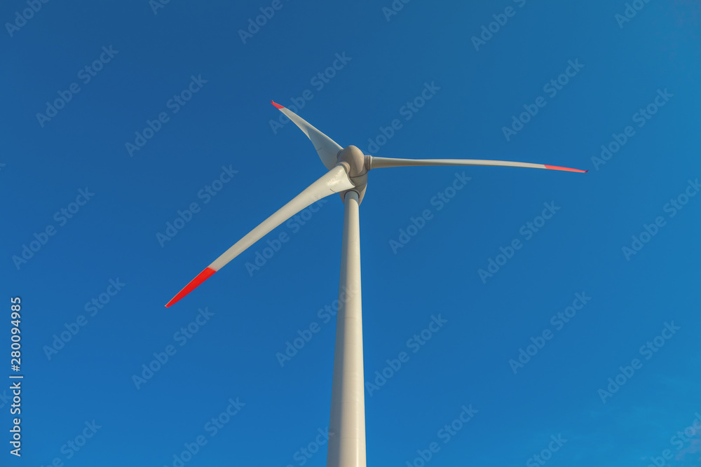 wind turbine with sun flare blue sky background view from below wind turbine with sun flare blue sky background view from below