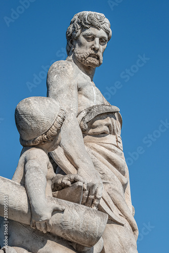 Sculpture of engineer and his scholar on Zoll Bridge in Magdeburg downtown, Germany, sunny day, blue sky