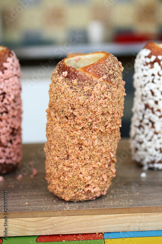 Traditional Hungarian roll kurtosh with ground nuts on a counter in a pastry shop photo