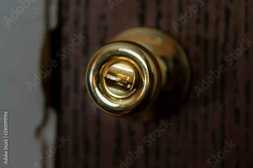 Door knob illuminated in dark room, gold doorknob at night 