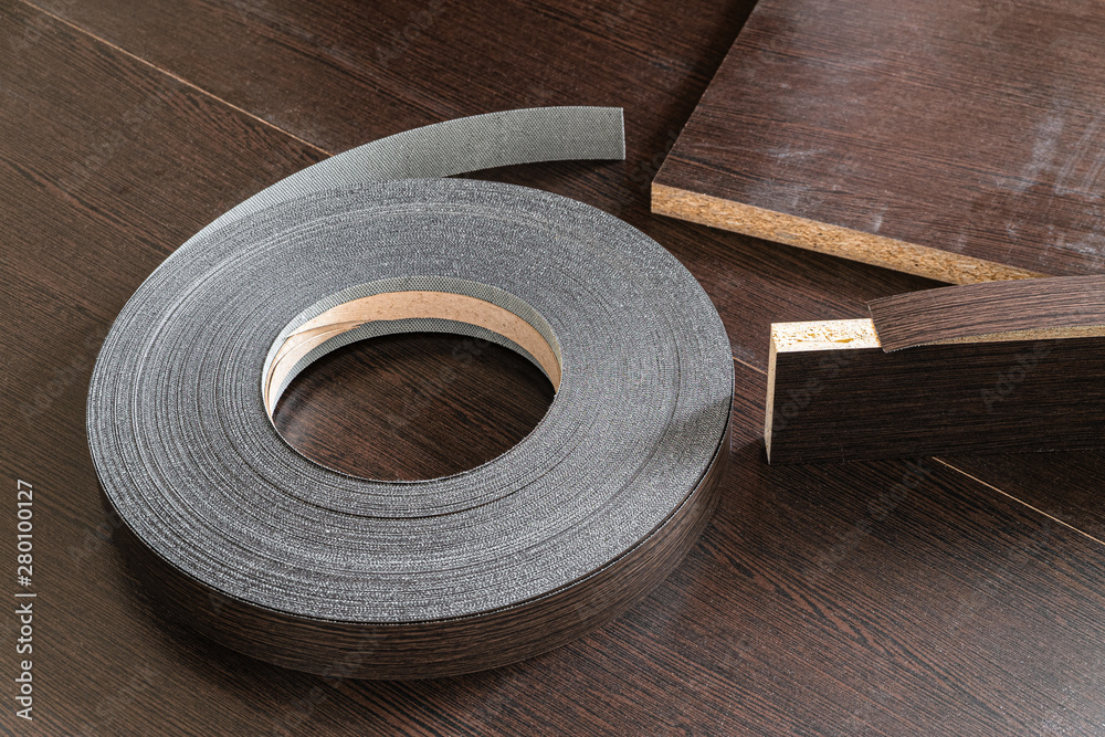 Roll melamine edge for finishing furniture. Edging tape on laminated wenge color. Stock Photo | Adobe Stock