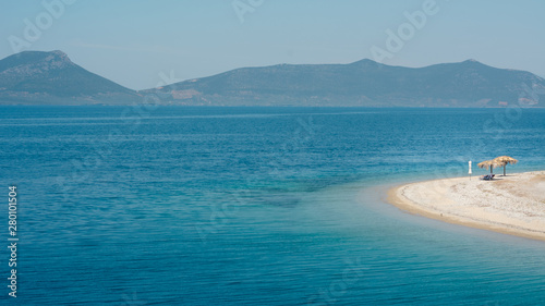 Empty beach in Greece with one sunshade photo