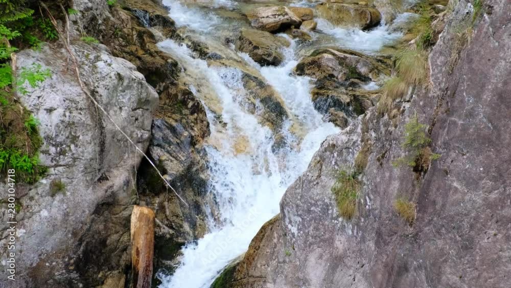 mountain waterfall flowing on the rocks mountain waterfall flowing on the rocks