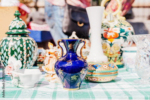 Fotografi Old porcelain vases and other vintage objects at flea market, France
