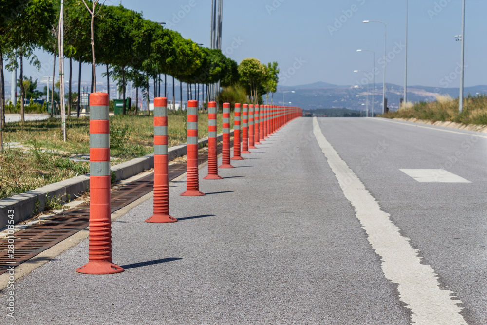 Parking barrier for traffic safety. No car parking. Red plastic fencing cones barriers