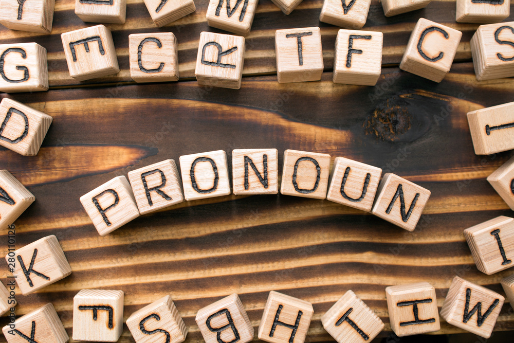 word pronoun composed of wooden cubes with letters, Part of speech concept scattered around the cubes random letters, top view on wooden background word pronoun composed of wooden cubes with letters, Part of speech concept scattered around the cubes random letters, top view on wooden background
