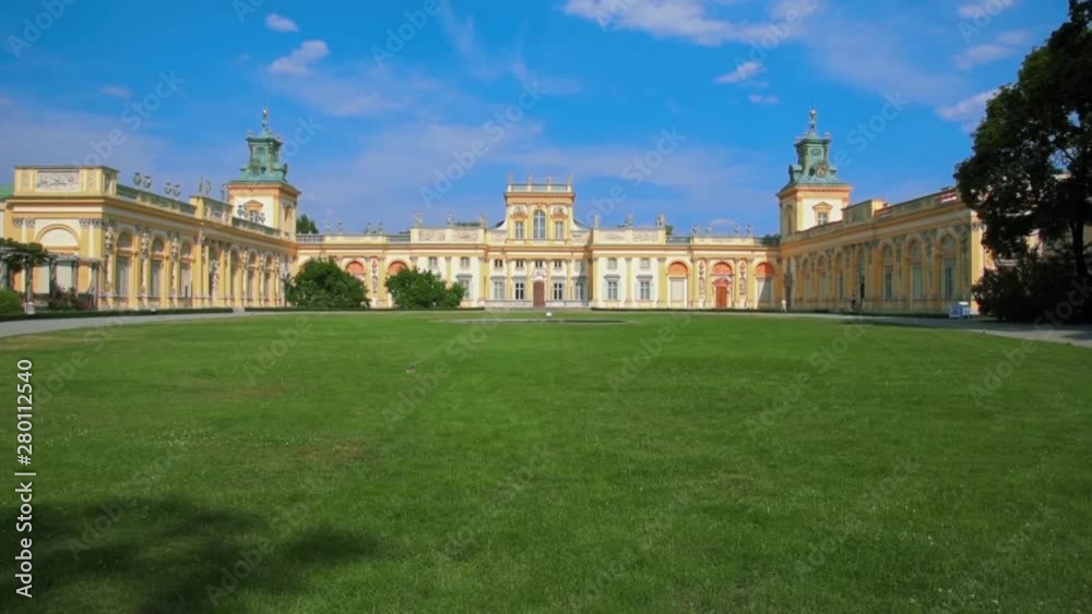 Facade of Old Historical Royal Palace in Warsaw, Poland at Summer Day with Blue Sky and Green Grass Facade of Old Historical Royal Palace in Warsaw, Poland at Summer Day with Blue Sky and Green Grass