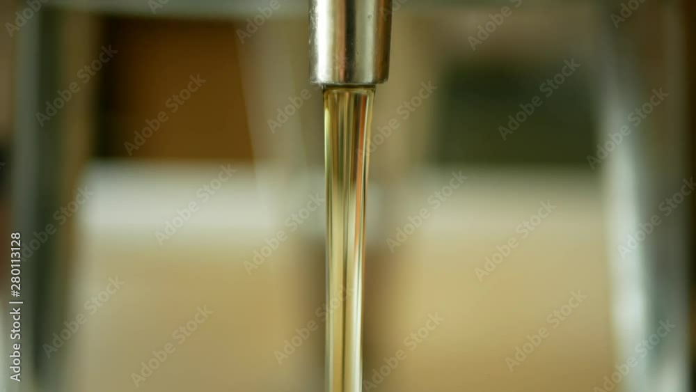 Sunflower oil organic quality bio, pouring in a steel barrel, for cold food and fried foodstuff, healthy cooking, gold seeds, vegetarian cuisine, filling bowl Sunflower oil organic quality bio, pouring in a steel barrel, for cold food and fried foodstuff, healthy cooking, gold seeds, vegetarian cuisine, filling bowl