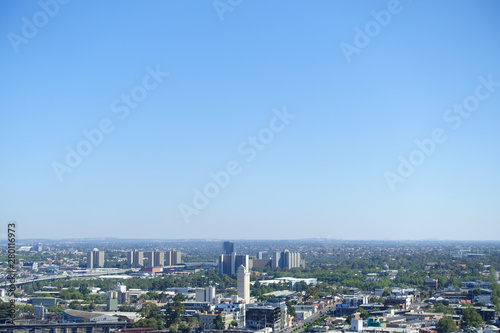Background texture of elevated Melbourne 's metropolitan view of western suburbs. Aerial view of suburban houses against cloudless blue sky. 