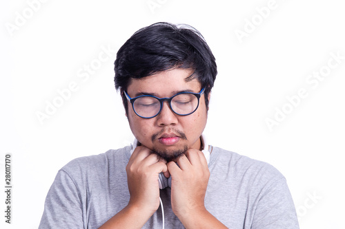 Young Asian man with mustached listen to the music with thinking face