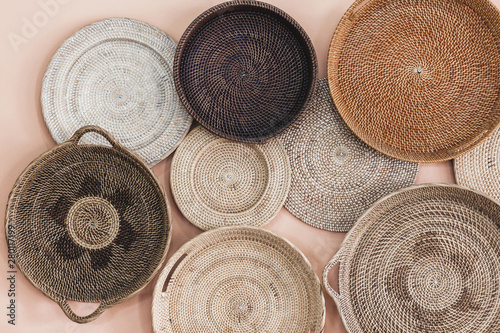 Wall decorated with different wicker handmade trays and baskets. Eco style and concept, Moroccan culture.
