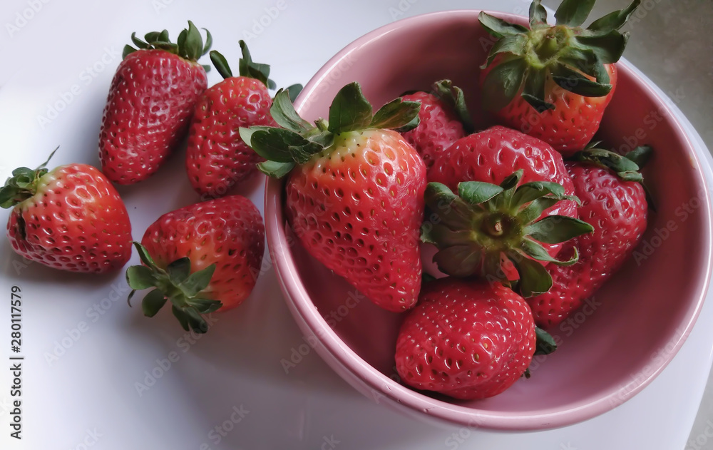 strawberries in a pink bowl strawberries in a pink bowl