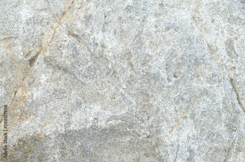 Granite rocks with faults, a background of old stones Granite rocks with faults, a background of old stones