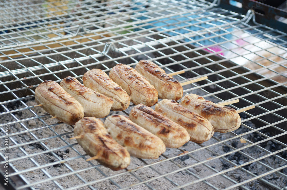Grilled banana in a charcoal grill background Grilled banana in a charcoal grill background