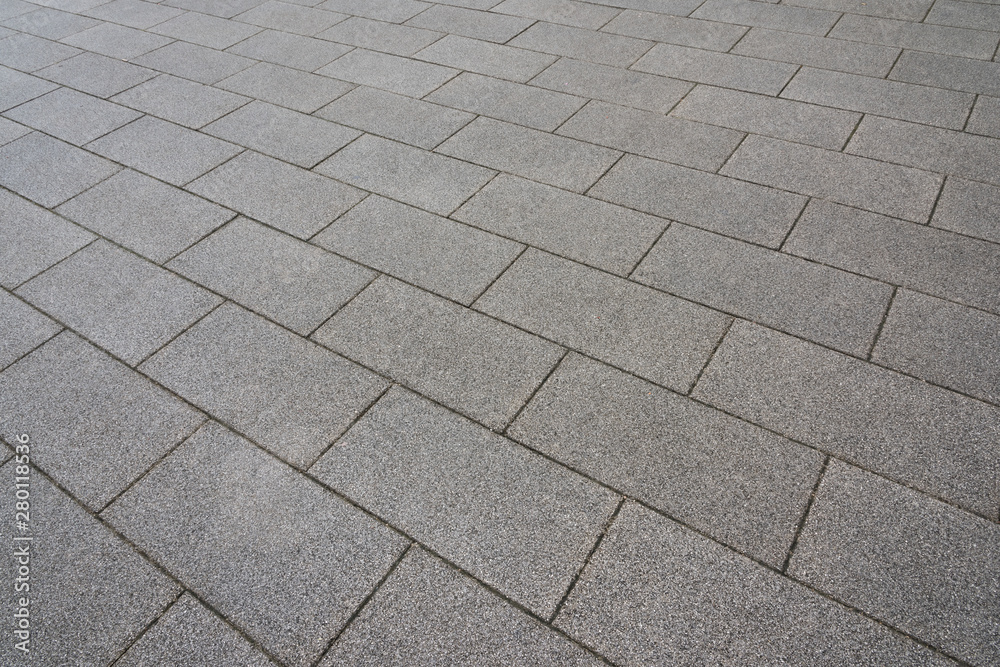 Retro style structure texture of gray square stone paved square in city park